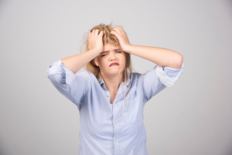 angry woman pulling her hair gray surface