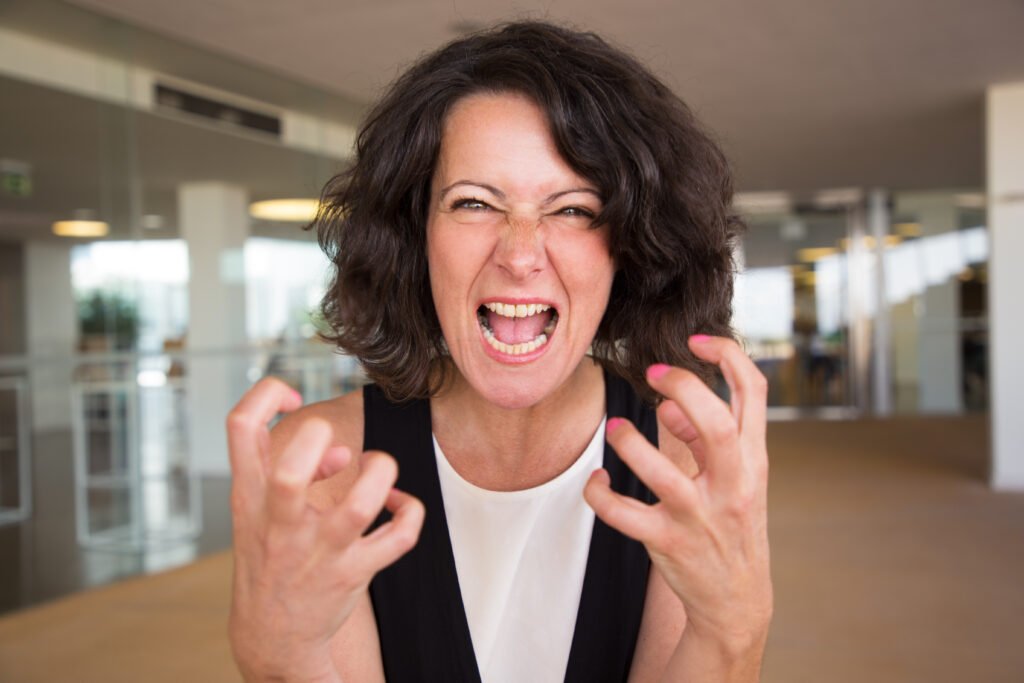 crazy furious woman shouting at camera