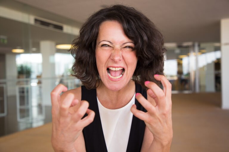 crazy furious woman shouting at camera