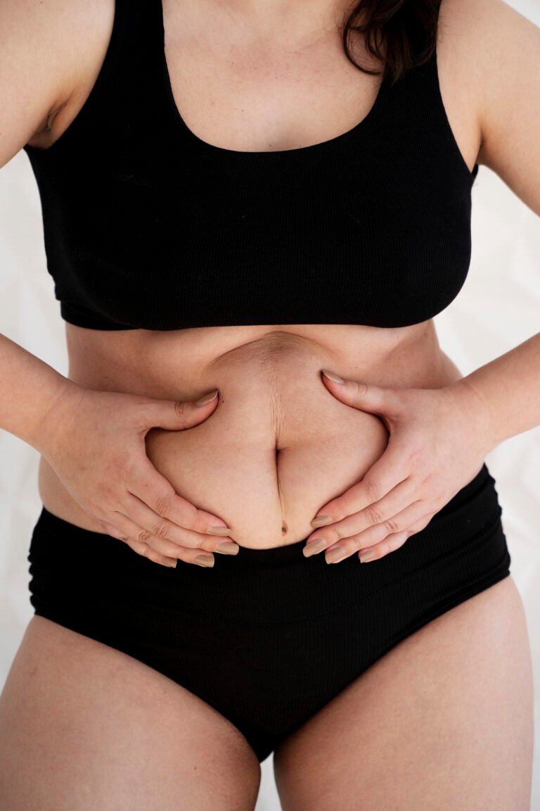 front view woman holding her belly