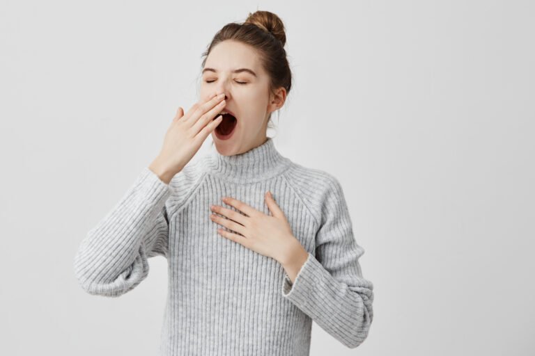 tired woman yawning covering open mouth with hand need rest. young female worker being sleepy head can't wake up having insomnia. chain reaction